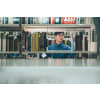 Man choosing a book in a library