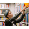 a young subculture punk woman in the library