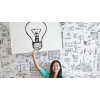Woman holding a sign of a lightbulb