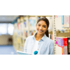 Female student smiling with a book in the library