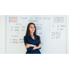 Female English teacher standing in front of a whiteboard