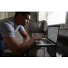 Man using his laptop to look at data analytics