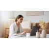 Woman using her computer while studying