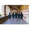 Students wearing their graduation gowns and caps walking around their campus before their graduation ceremony