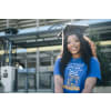 Woman wearing a graduation cap with a plain blue shirt