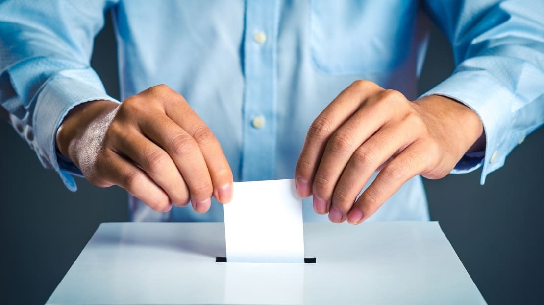 A pair of hand submitting a vote