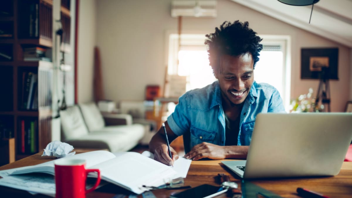 Happy man studying from home