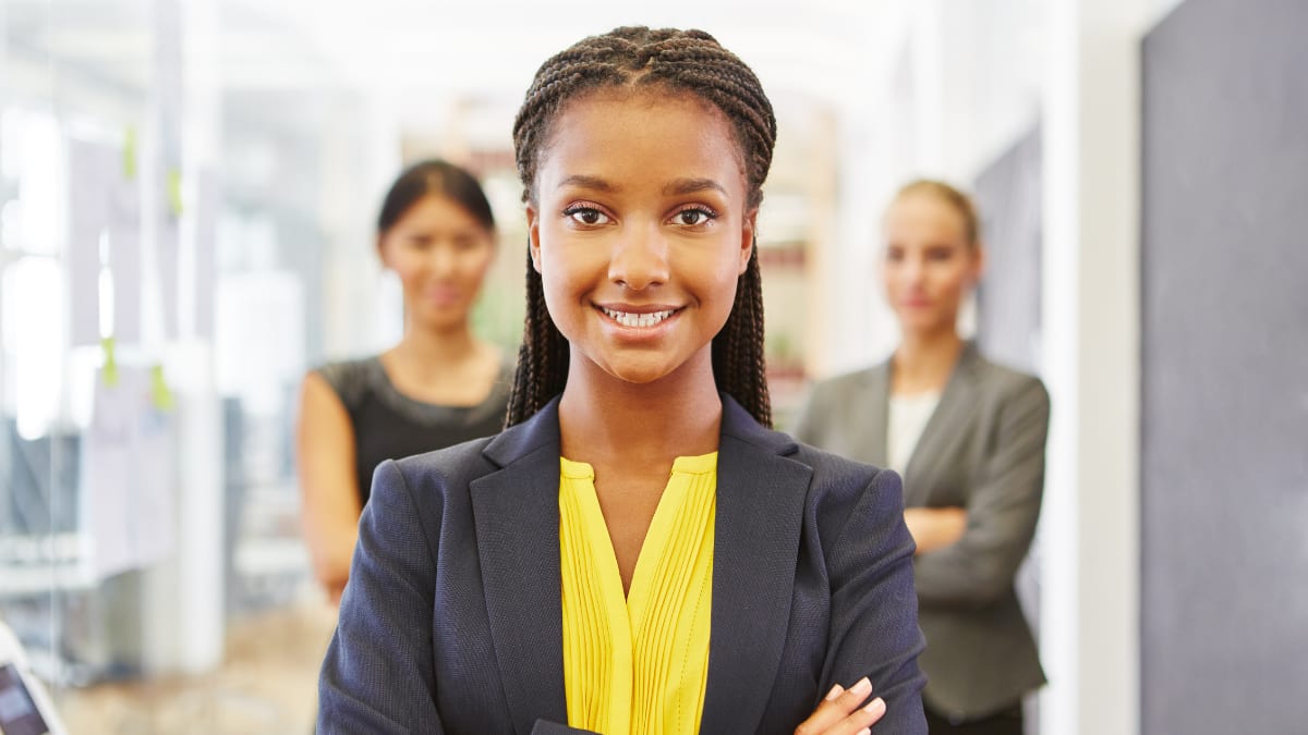 Three businesswomen with folded arms