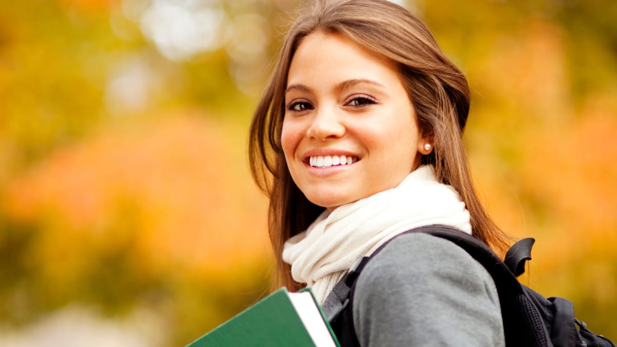 Happy female student outside