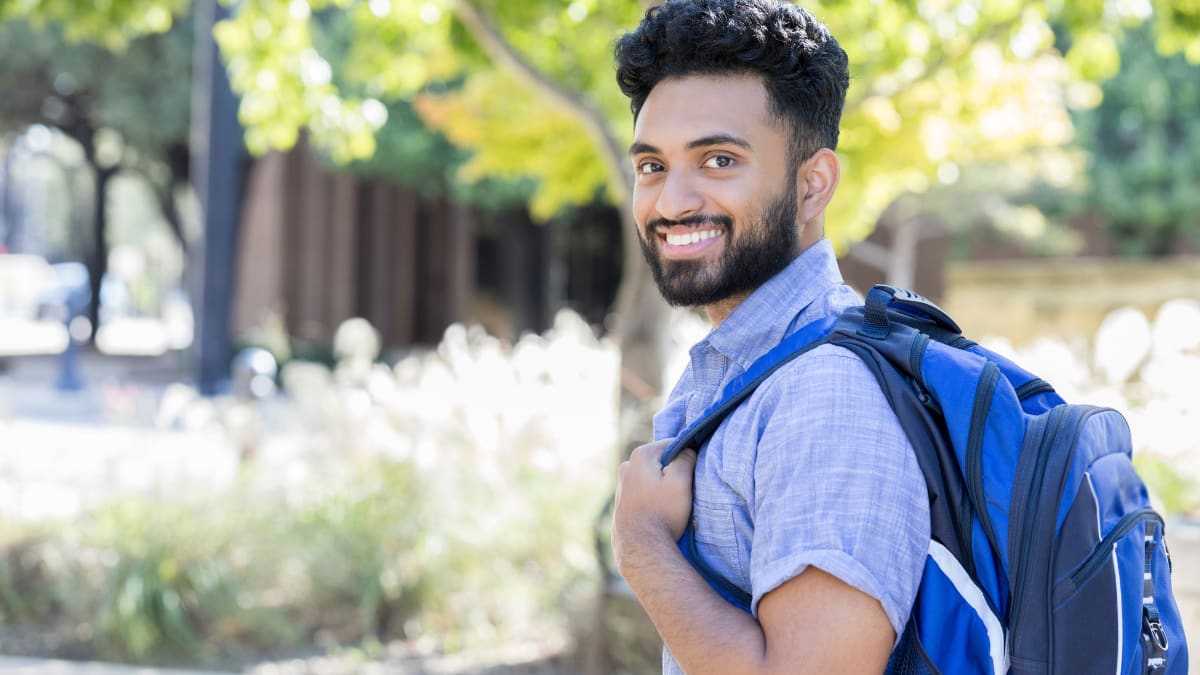 Smiling male student outside