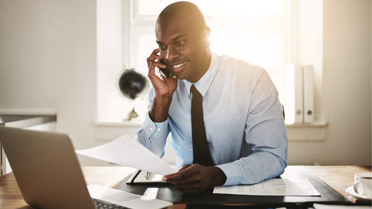 Happy businessman on a phone call