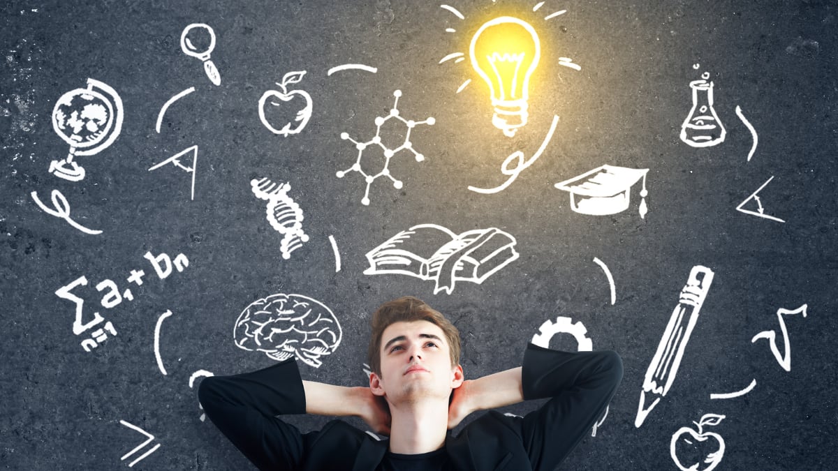 Student with education symbols on a blackboard