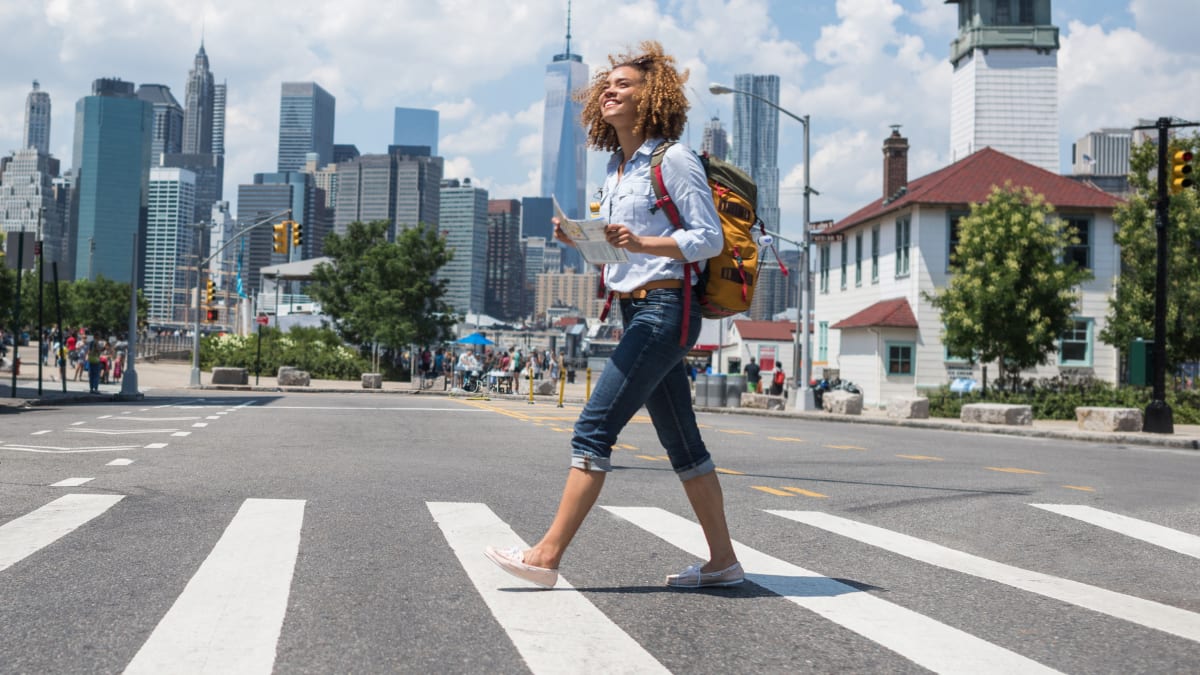 Female student walking across a street