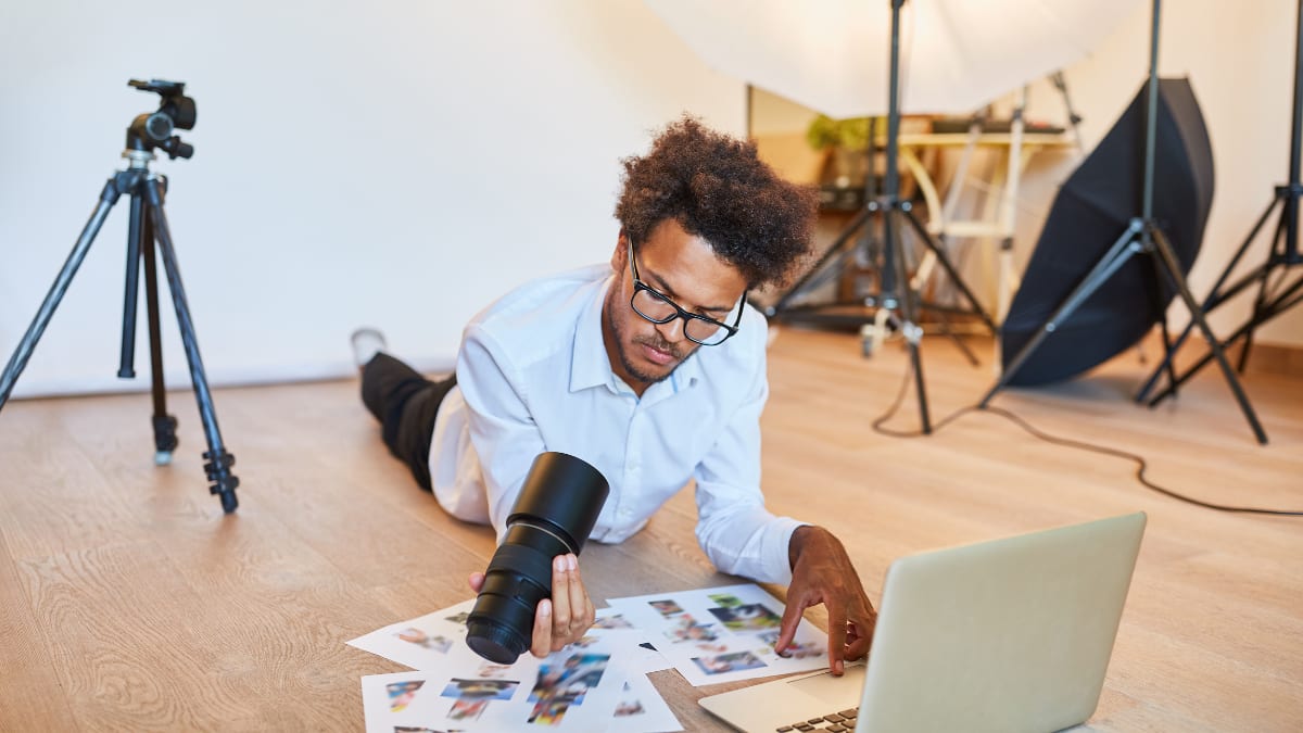 Designer looking a camera lens