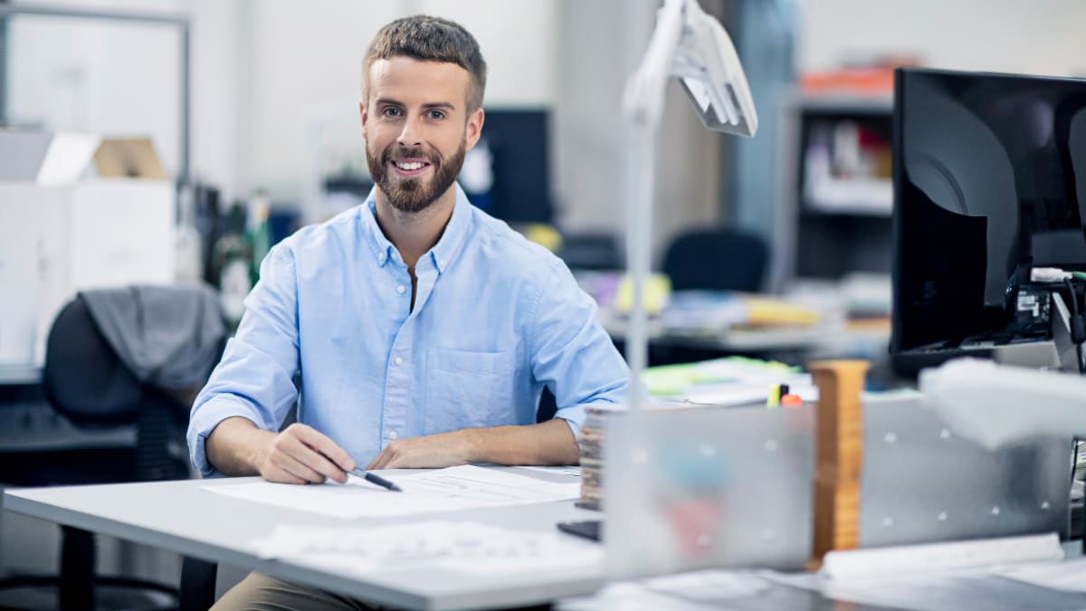 Designer smiling in a blue shirt