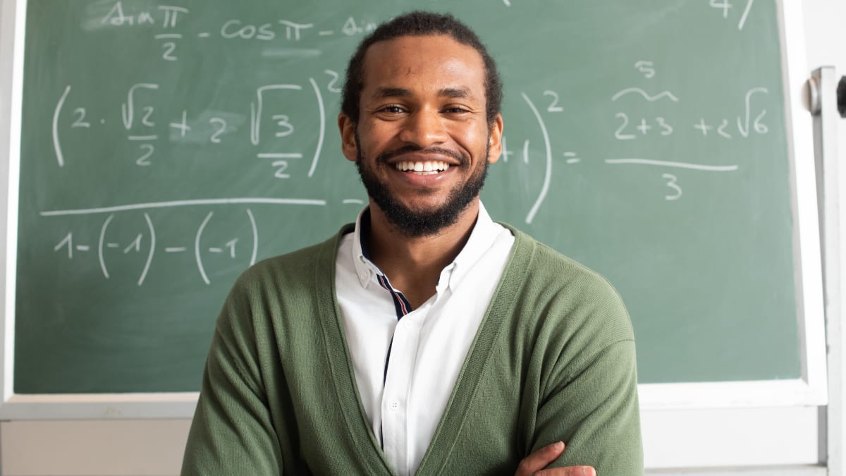 Man smiling in front of math equations