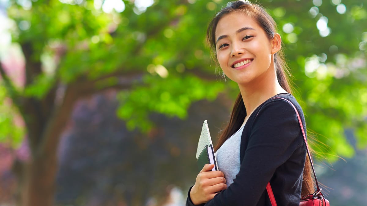 Proud female student outside