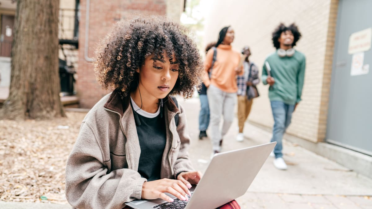 Student studying business outside