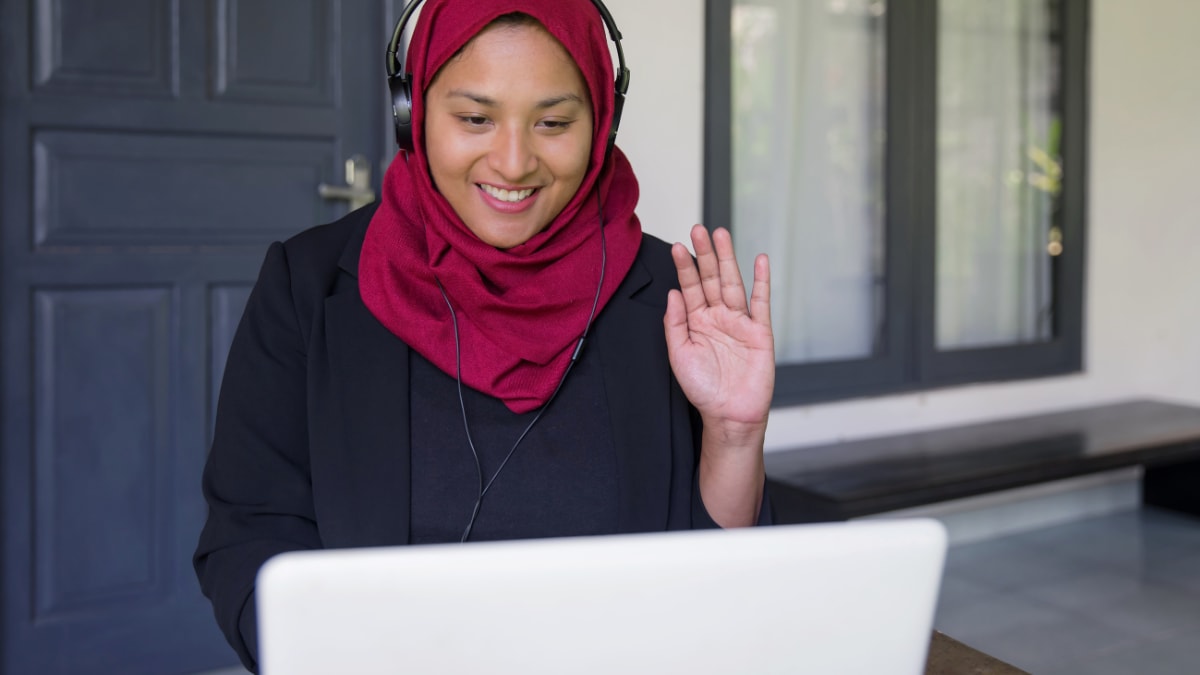 Woman waving on a video call