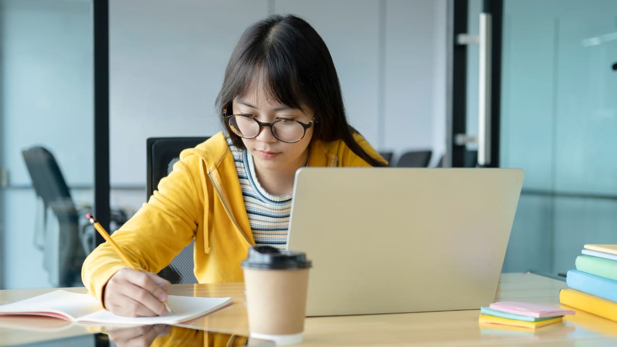 Female students with glasses taking notes