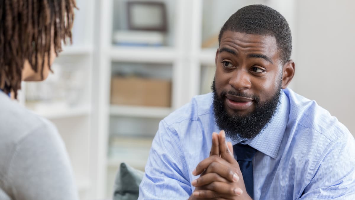 Man counseling a woman