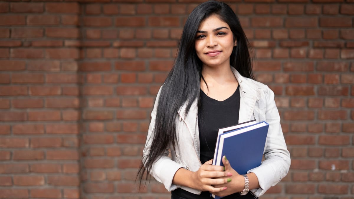 Female student holding books