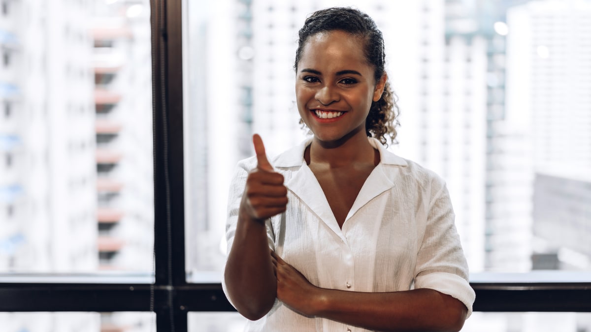 Smiling woman giving a thumb's up