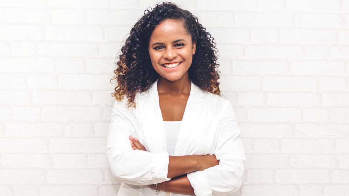 Smiling female businesswoman with arms crossed