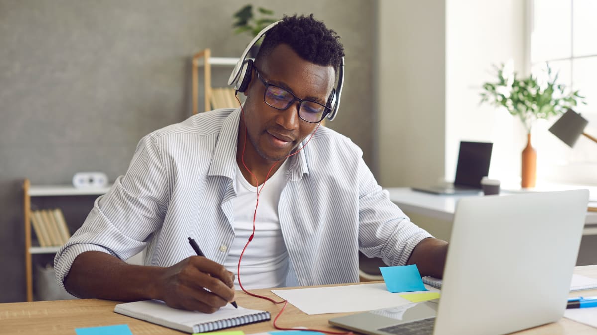 Man working at a desk wearing headphones