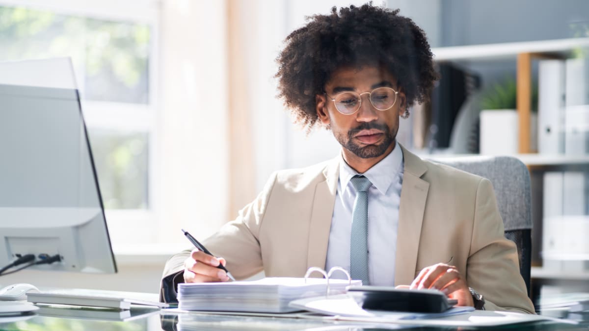Accountant with glasses looking over taxes