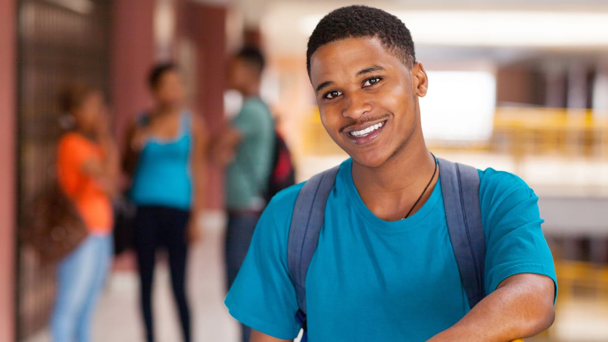 Male student smiling in a blue shirt
