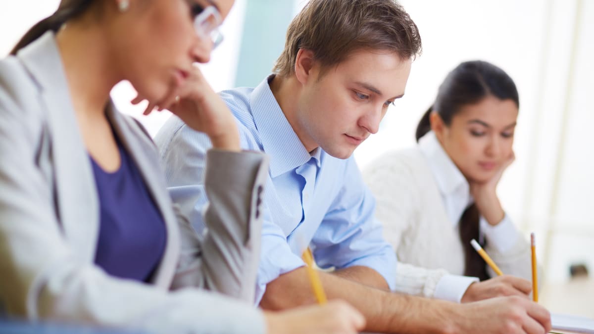 Three students working for their MBA