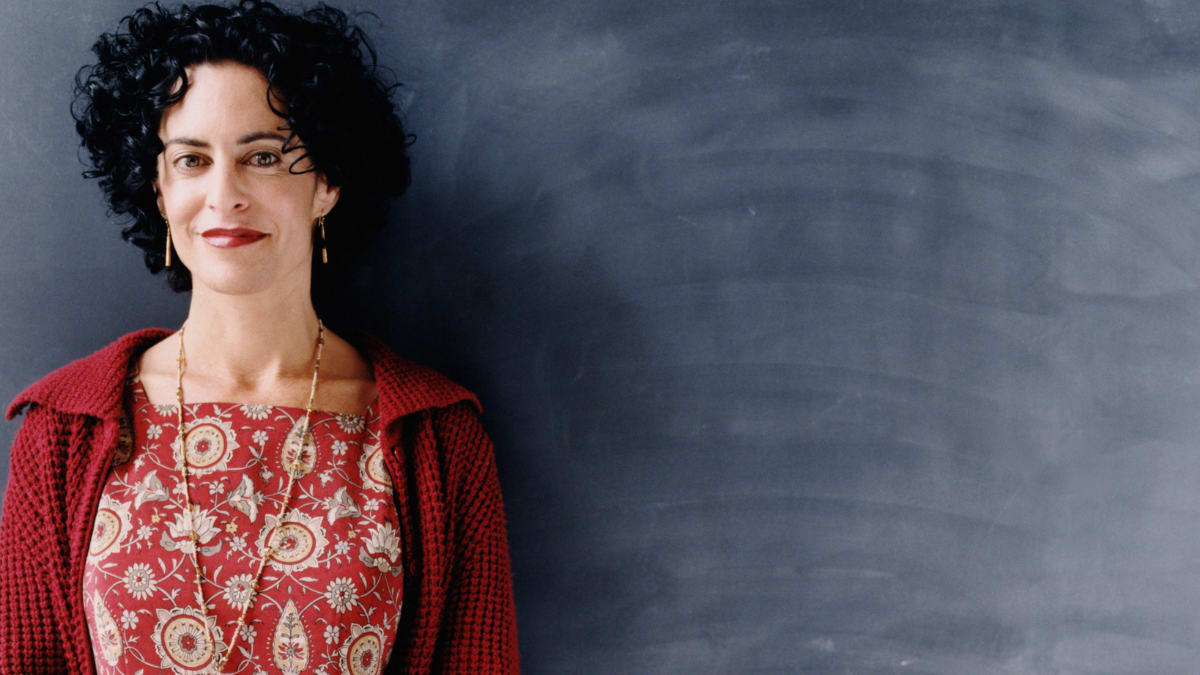 Teacher in front of a black board