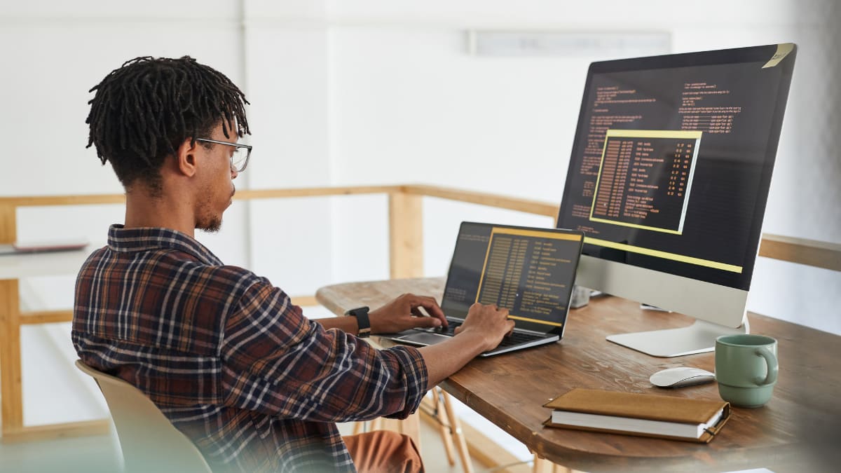 Man with glasses coding