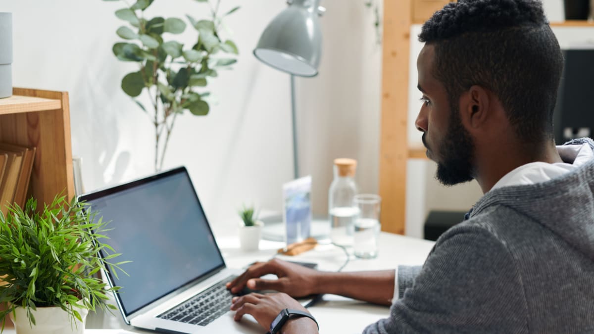 Male student studying on a laptop