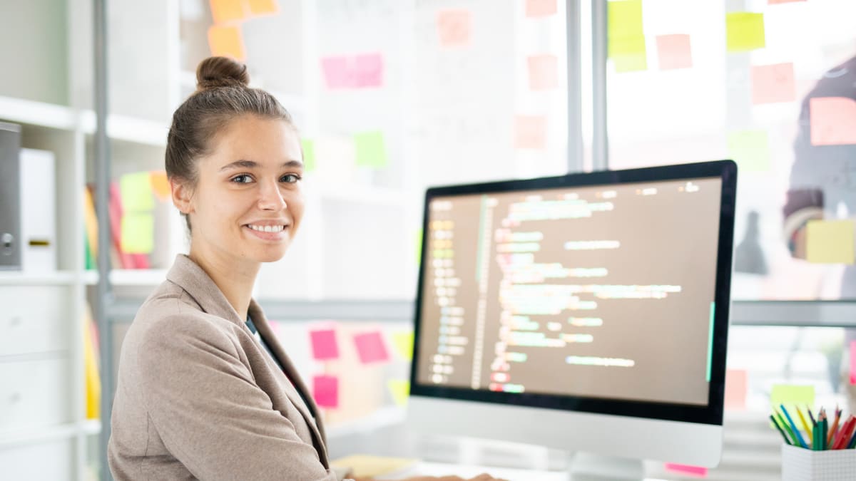 Woman smiling at writing code