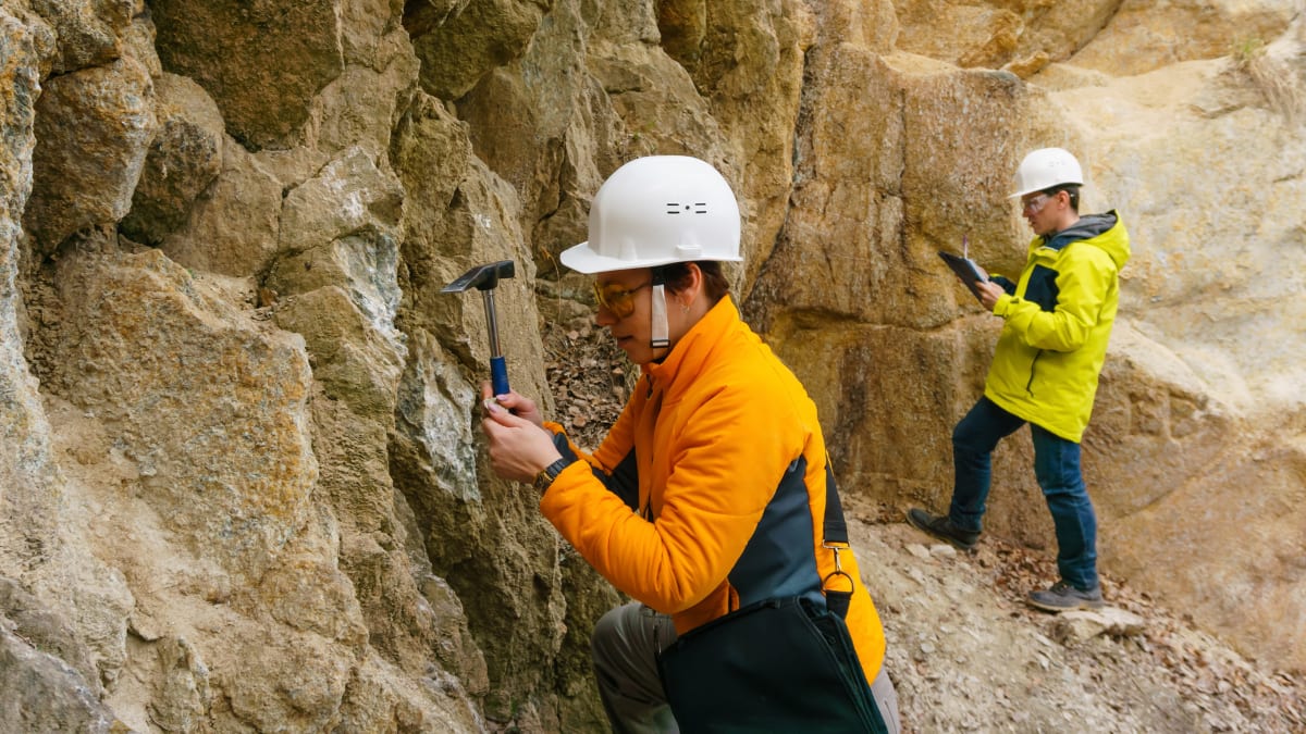 Two men studying rocks