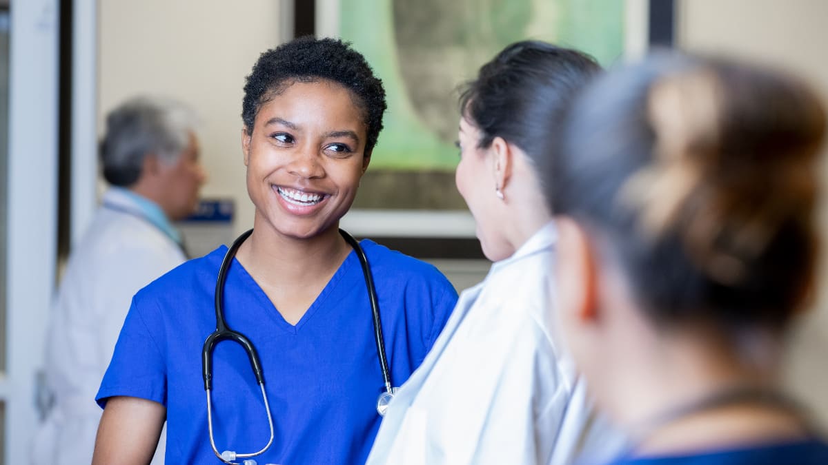 Happy nurse speaking to a doctor