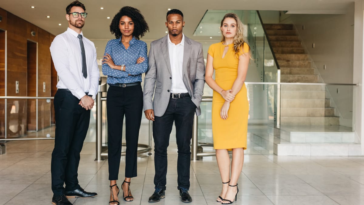 Serious young professionals standing in a lobby