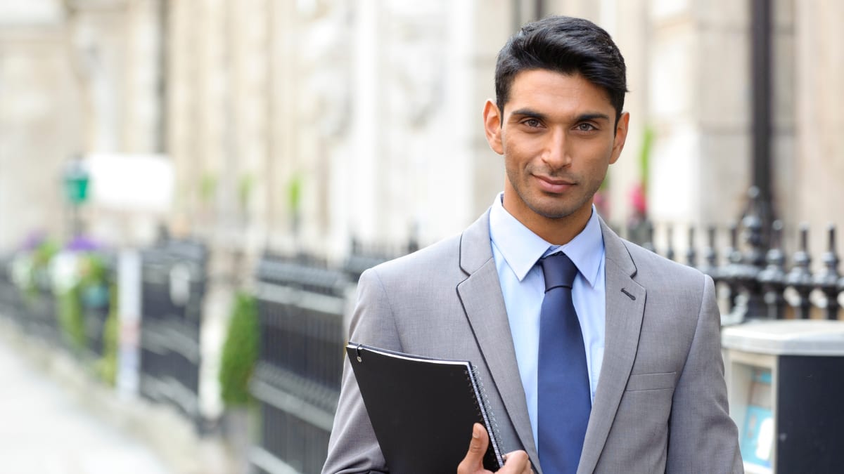 Businessman smirking with a binder