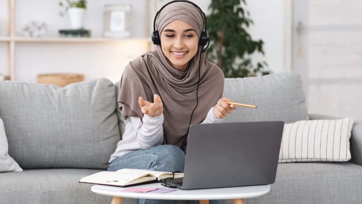 Woman on a video call with a pencil in hand