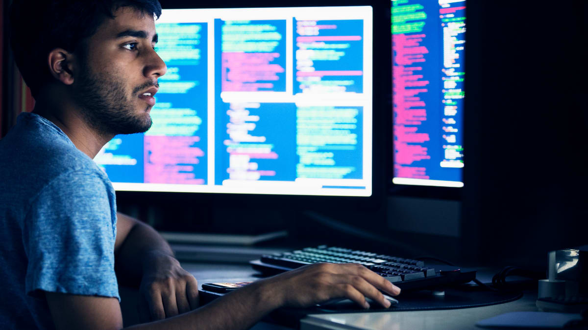 Man coding in the dark