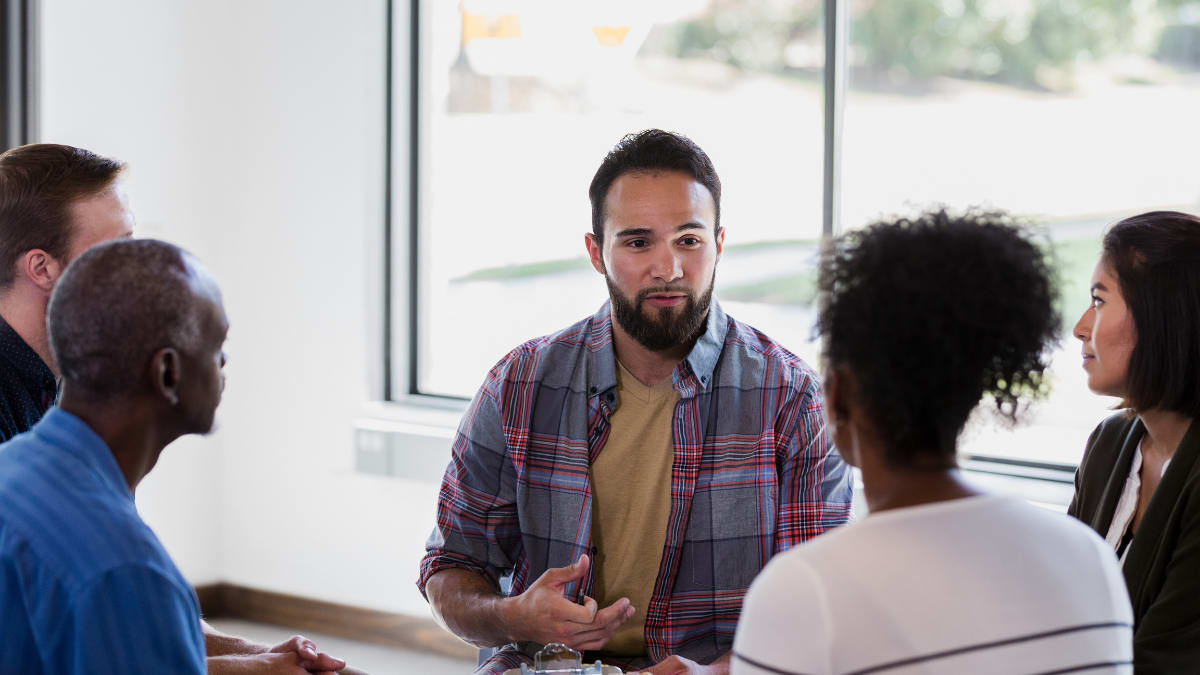 Man counseling a group of people