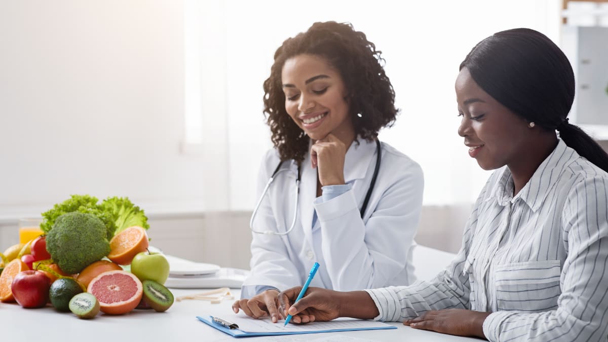 Health professional speaking to a young woman