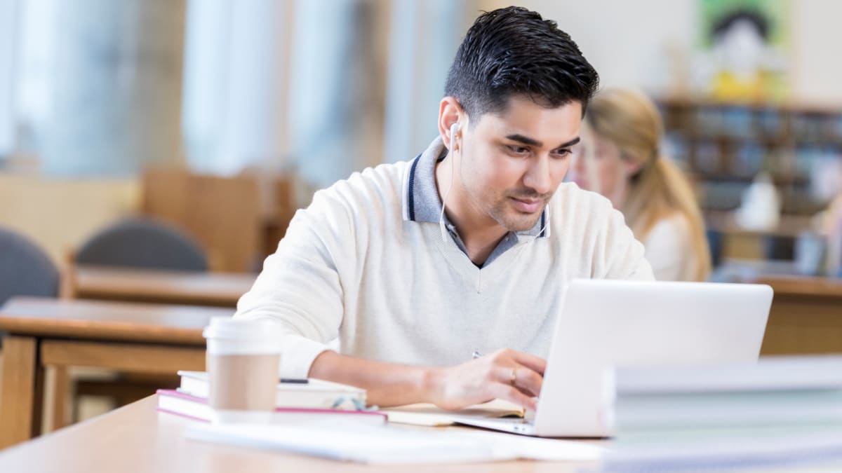 Man studying public health in a library