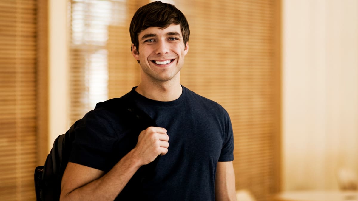 Student with backpack smiling