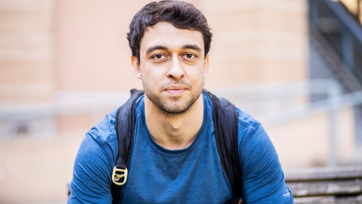 Student in a blue shirt and backpack