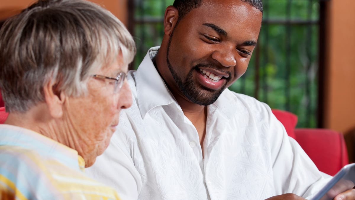 Man helping older woman