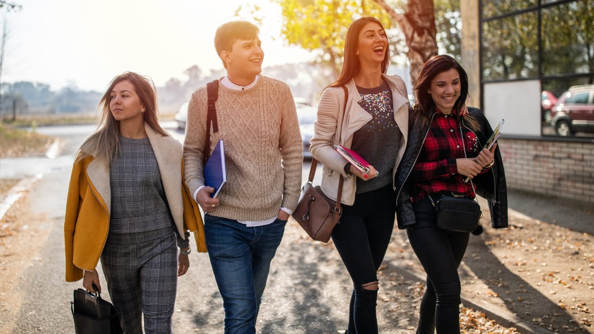 Four students walking outside