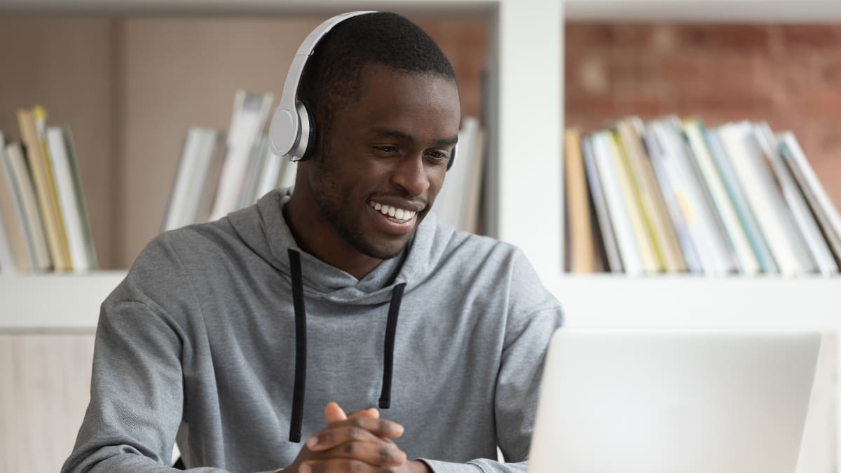 Man smiling at a laptop